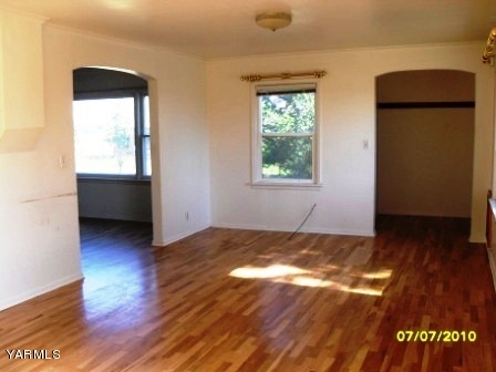 442 Hatton Road Tieton, WA 98947 - Photo 4 of 8 an empty room with wooden floor and windows