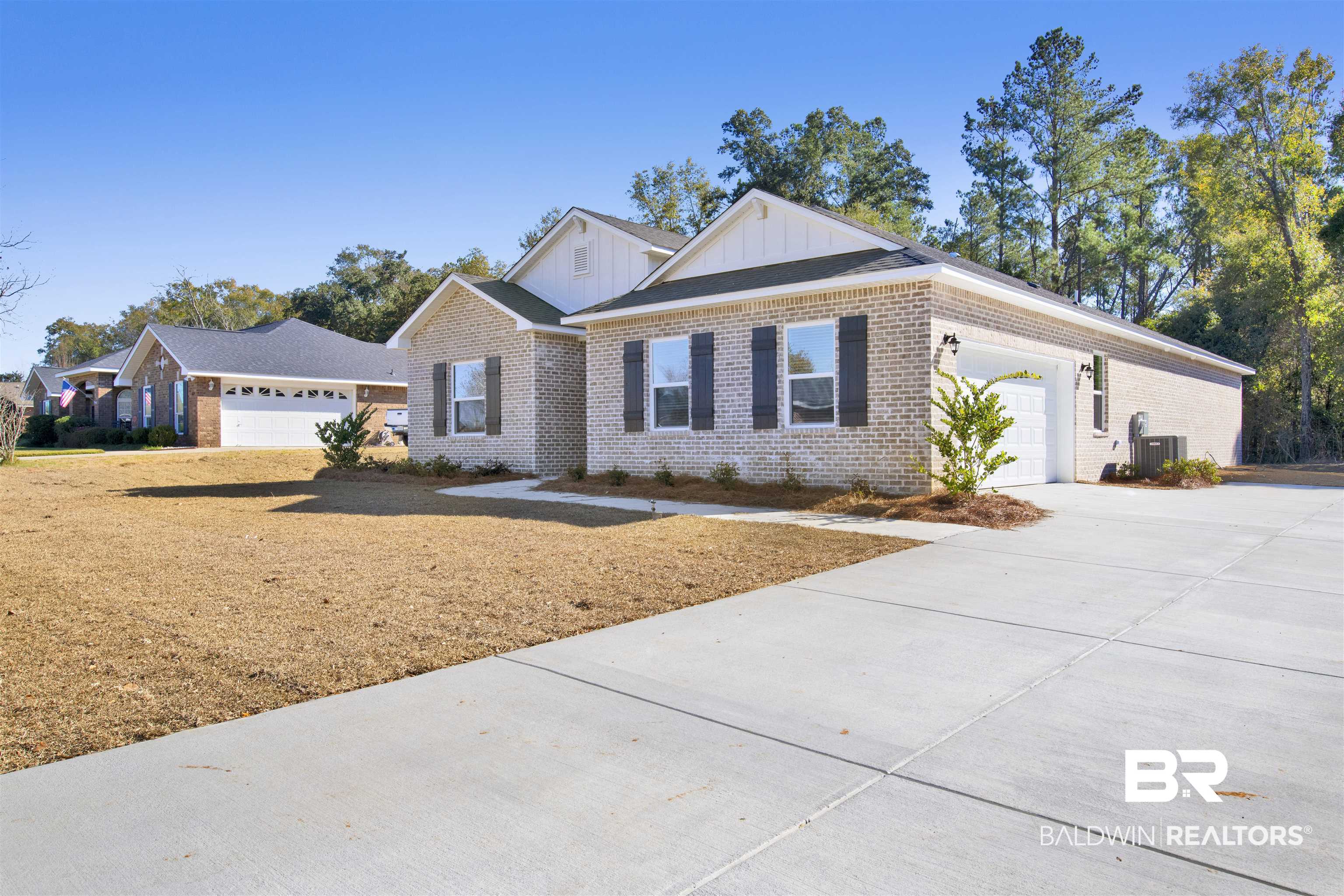 View of front of house with central AC and a garage