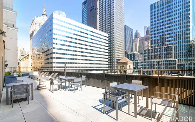 a view of balcony and chairs and tables