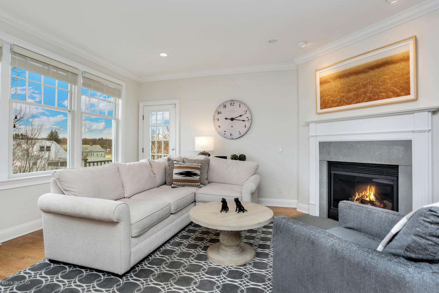 54 Valley Road, Unit A Cos Cob, CT 06807 - Photo 11 of 32 a living room with furniture a large window and a fireplace