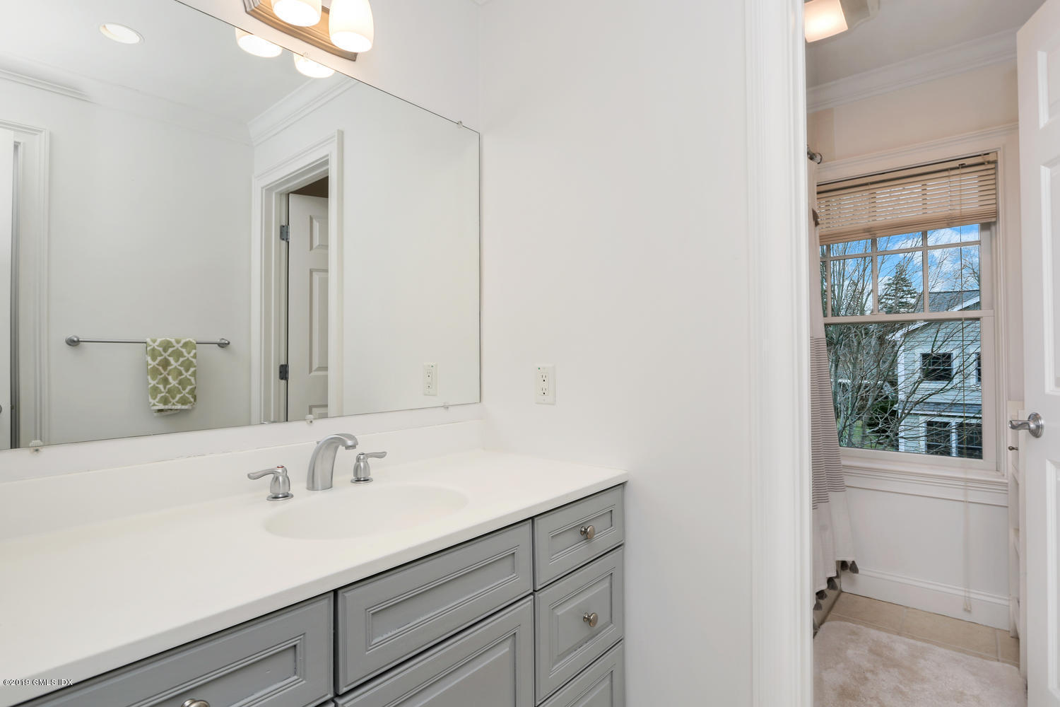 54 Valley Road, Unit A Cos Cob, CT 06807 - Photo 20 of 32 a bathroom with a sink and a mirror