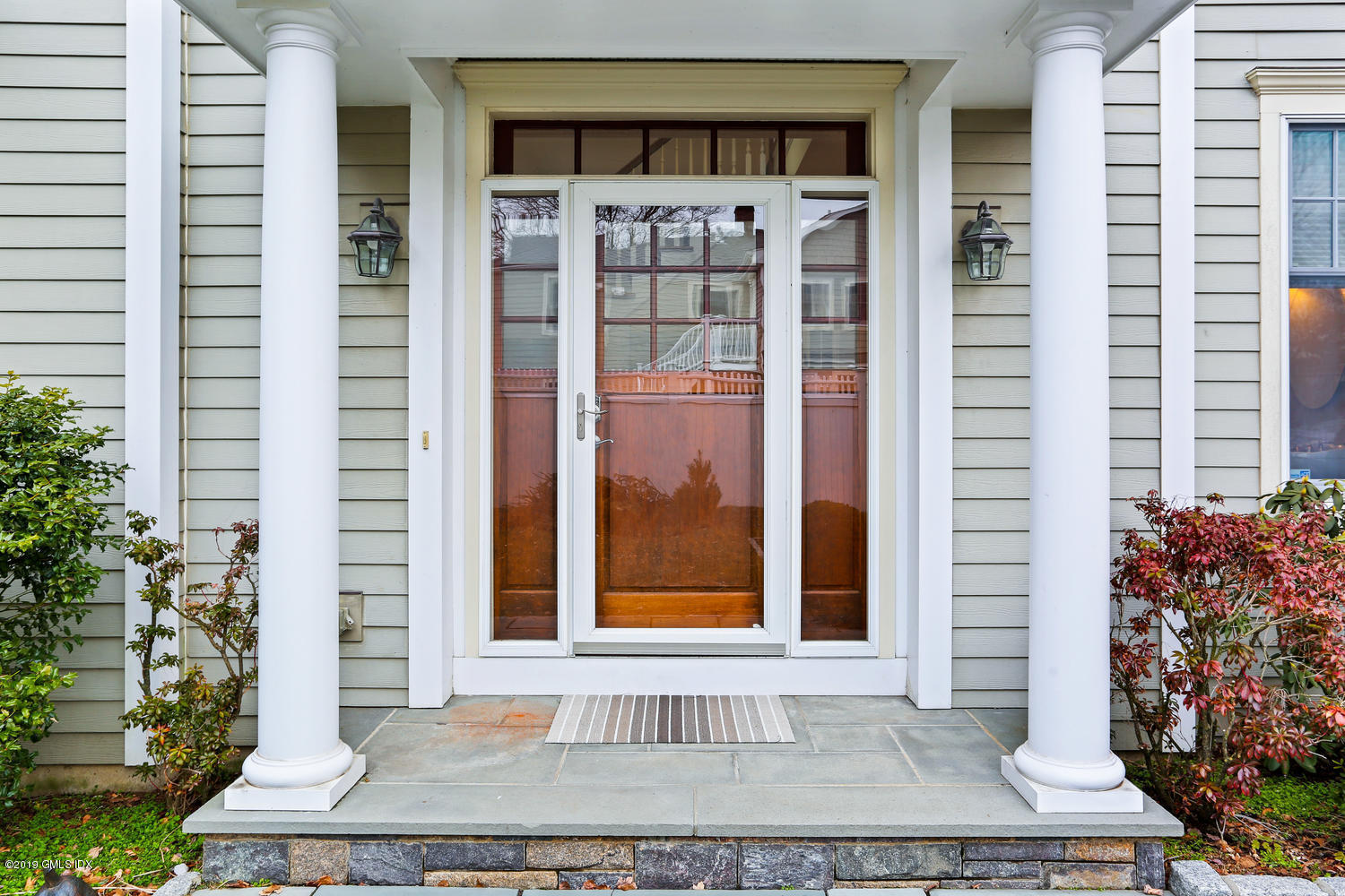 54 Valley Road, Unit A Cos Cob, CT 06807 - Photo 2 of 32 a front view of a house with a yard