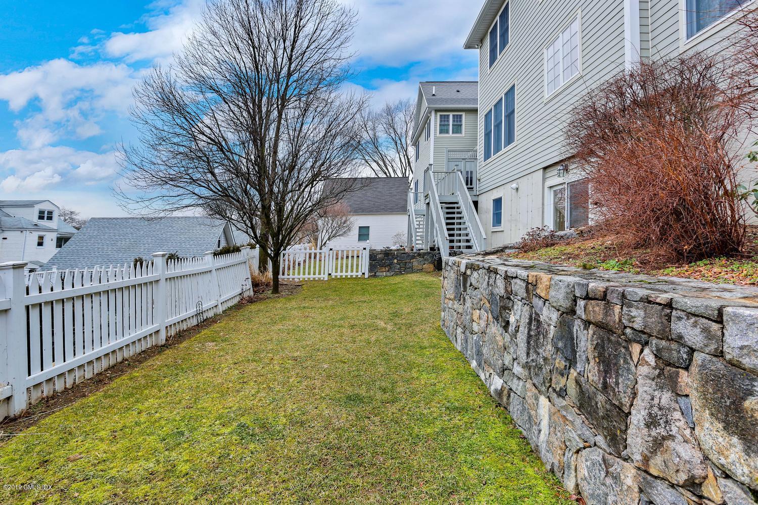 54 Valley Road, Unit A Cos Cob, CT 06807 - Photo 29 of 32 a view of a yard with brick house