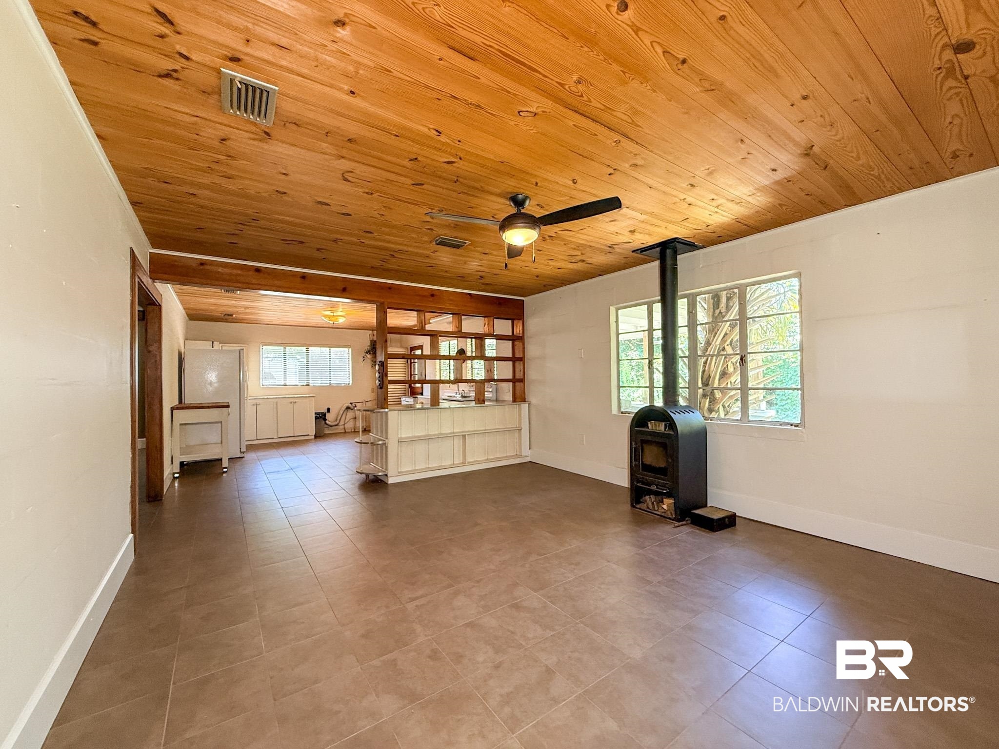 18711 Keller Road Foley, AL 36535 - Photo 7 of 38 Spacious room featuring a paneled wood ceiling and large format tile flooring