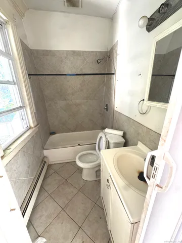 a bathroom with a sink a toilet and bathtub