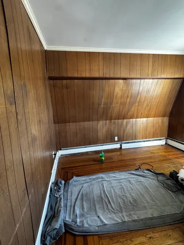 a view of a white house next to a yard