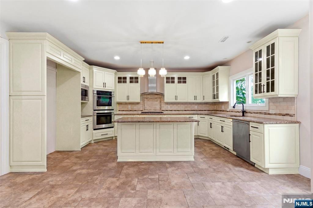 767 Orangeburgh Road River Vale, NJ 07675 - Photo 15 of 49 a large kitchen with kitchen island a sink stainless steel appliances and cabinets