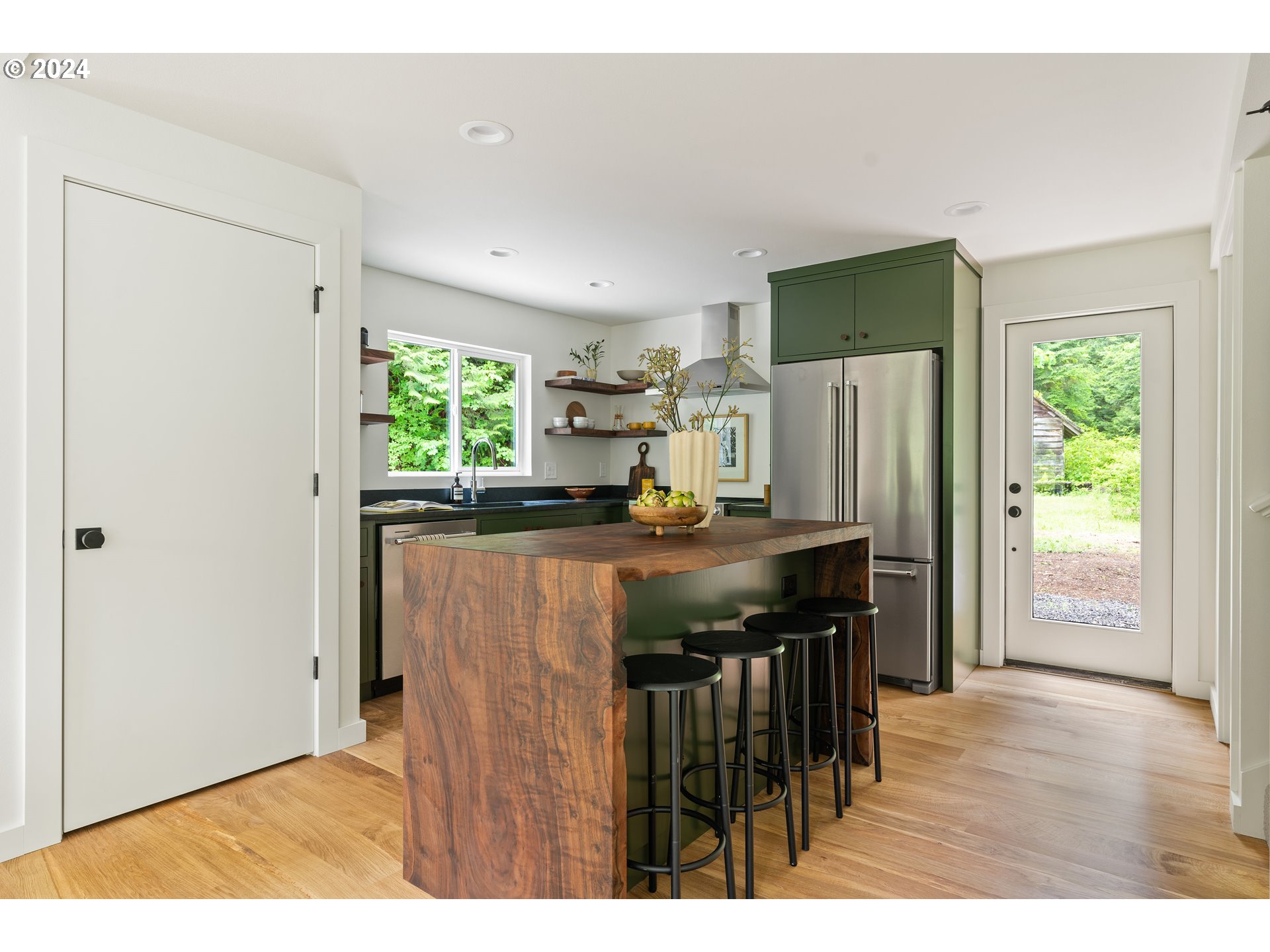 2162 Duncan Creek Road Stevenson, WA 98648 - Photo 14 of 38 a kitchen with stainless steel appliances granite countertop a refrigerator a sink a stove and a wooden floors