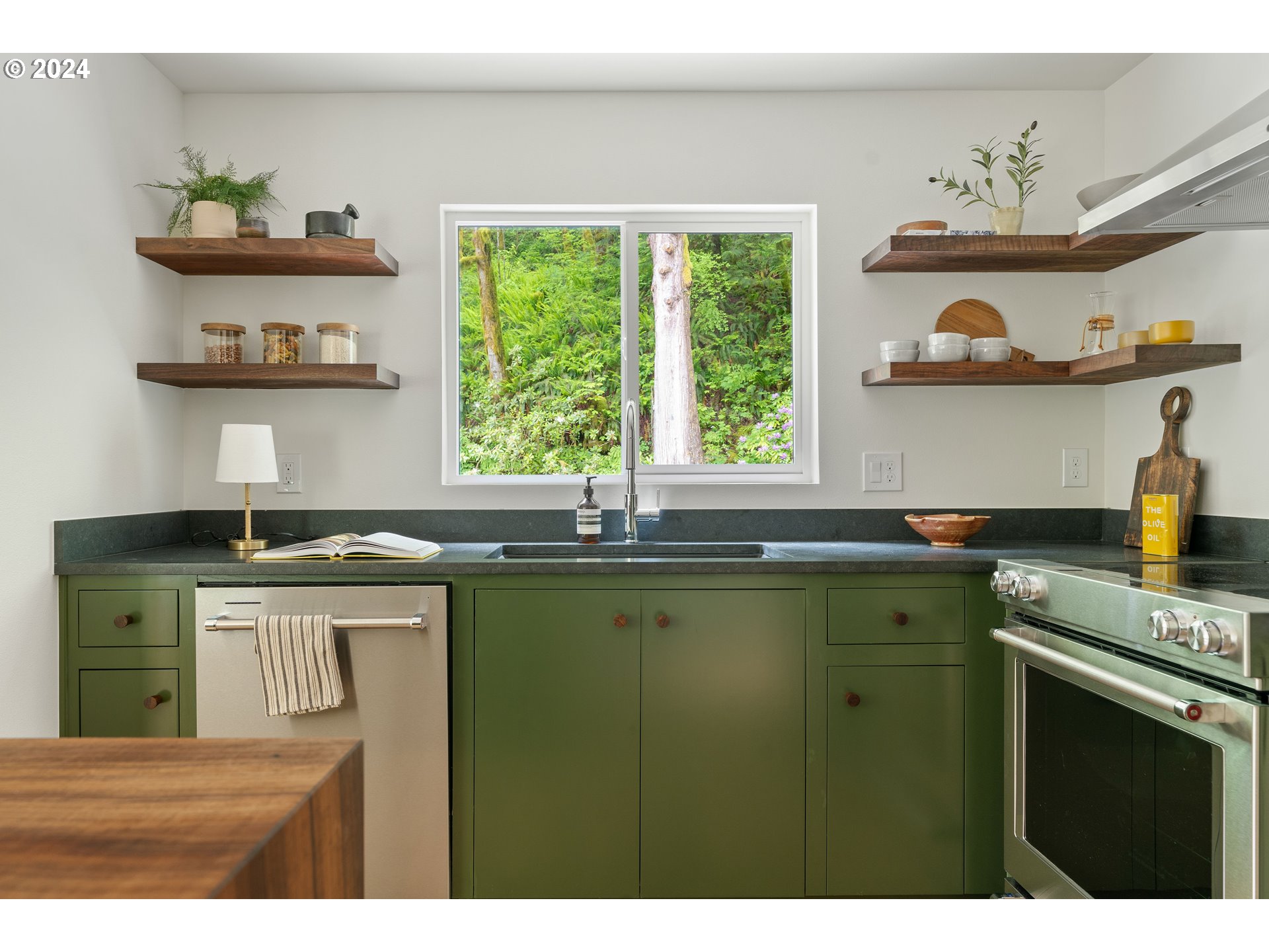 2162 Duncan Creek Road Stevenson, WA 98648 - Photo 15 of 38 a kitchen with stainless steel appliances a sink a stove and a window