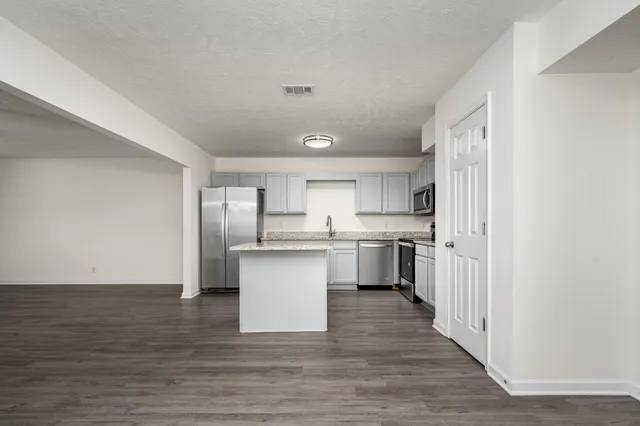 a kitchen with white cabinets and white appliances