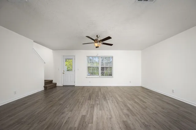 wooden floor in an empty room with a window