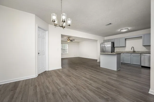 a view of a kitchen with a sink wooden floor and a kitchen