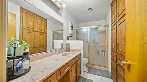 a bathroom with a granite countertop tub sink and mirror