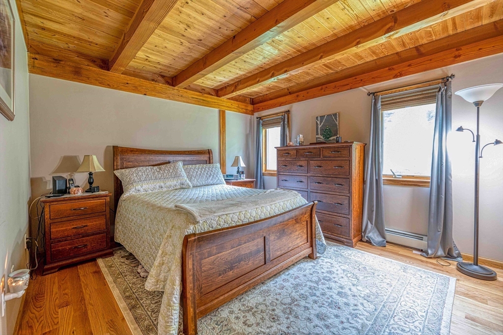 78 Howland Road Assonet, MA 02702 - Photo 12 of 41 a bedroom with a bed and wooden floor