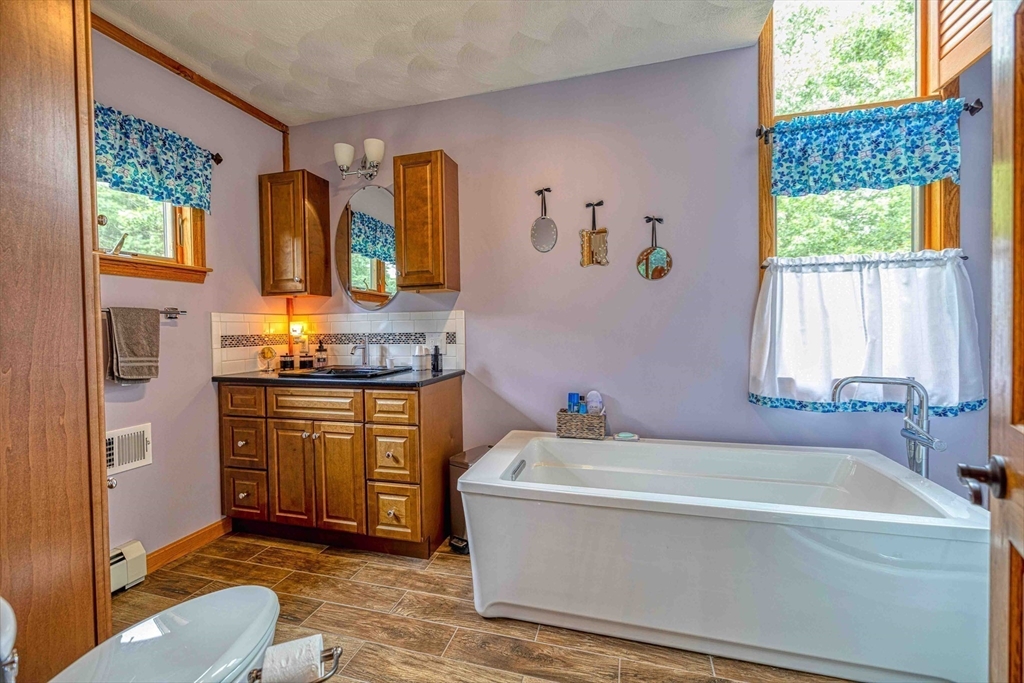 78 Howland Road Assonet, MA 02702 - Photo 19 of 41 a bathroom with a tub sink and mirror