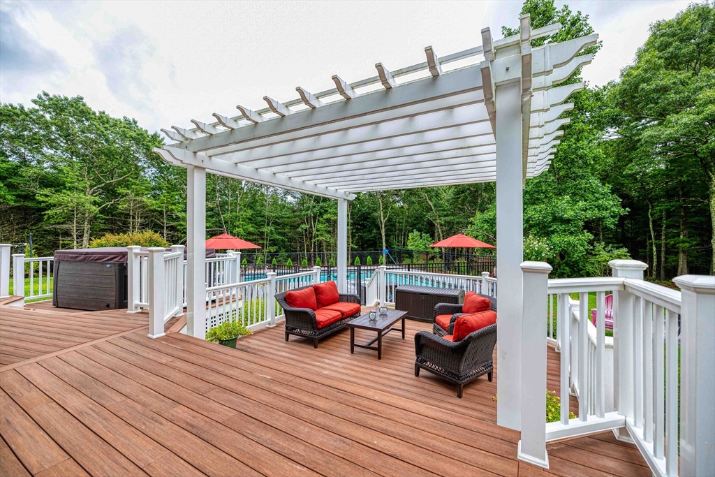 78 Howland Road Assonet, MA 02702 - Photo 33 of 41 a view of a roof deck with table and chairs potted plants with wooden floor and fence