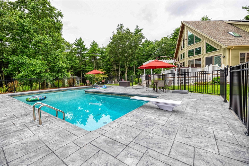 78 Howland Road Assonet, MA 02702 - Photo 34 of 41 a view of a patio with a table and chairs under an umbrella
