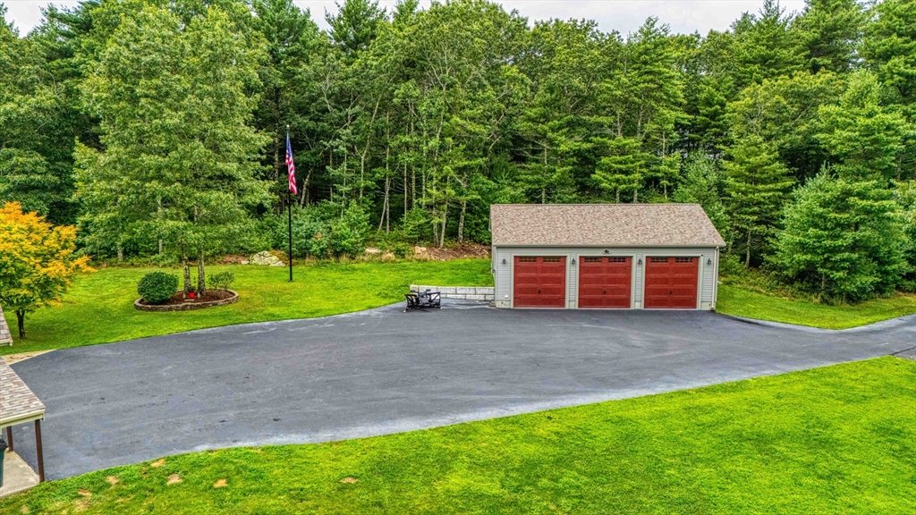78 Howland Road Assonet, MA 02702 - Photo 38 of 41 a front view of a house with a yard and garage