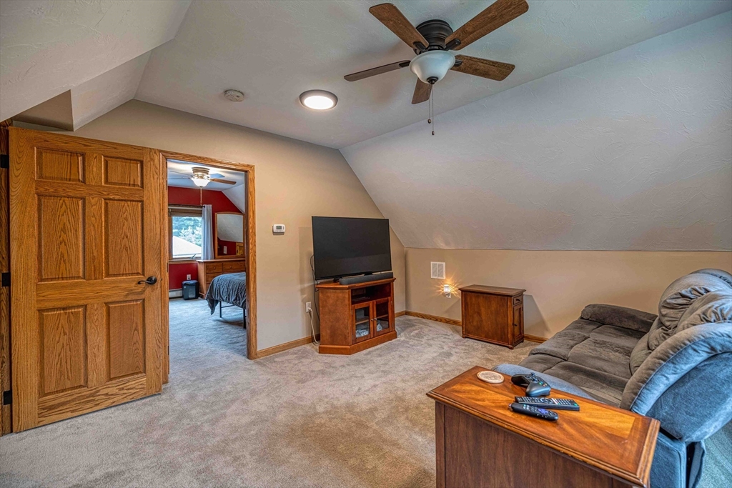 78 Howland Road Assonet, MA 02702 - Photo 6 of 41 a view of a livingroom with furniture and a flat screen tv