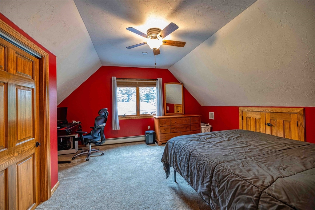78 Howland Road Assonet, MA 02702 - Photo 7 of 41 a bedroom with a bed and a chandelier