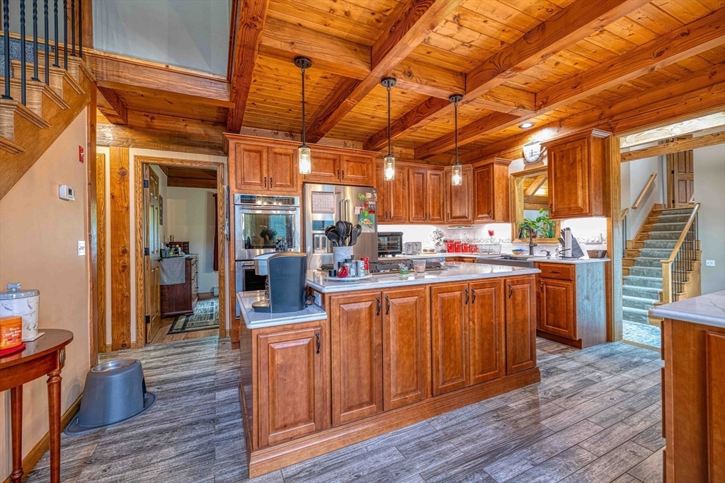 78 Howland Road Assonet, MA 02702 - Photo 8 of 41 a room with stainless steel appliances wooden floors and wooden cabinets