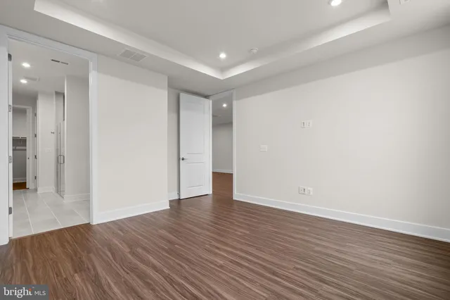 a view of an empty room with wooden floor