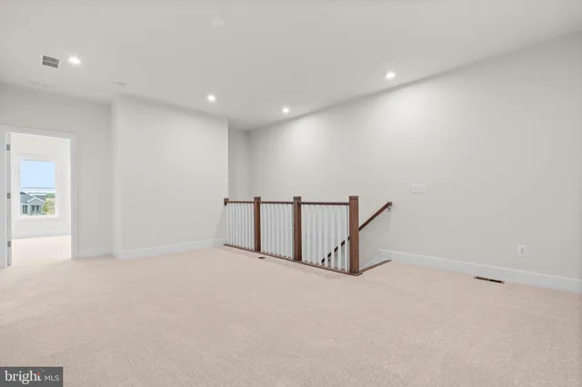 a view of staircase with white walls