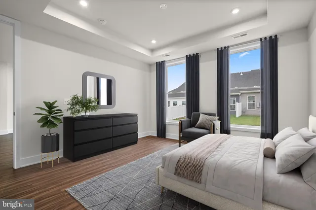 a bedroom with a large bed and a potted plant