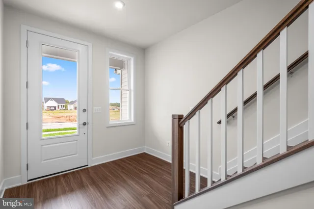 a view of an entryway with wooden floor and stairs