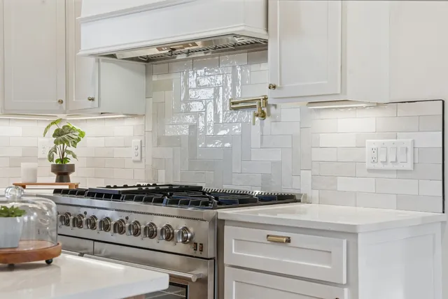 a kitchen with kitchen island granite countertop a sink cabinets and wooden floor