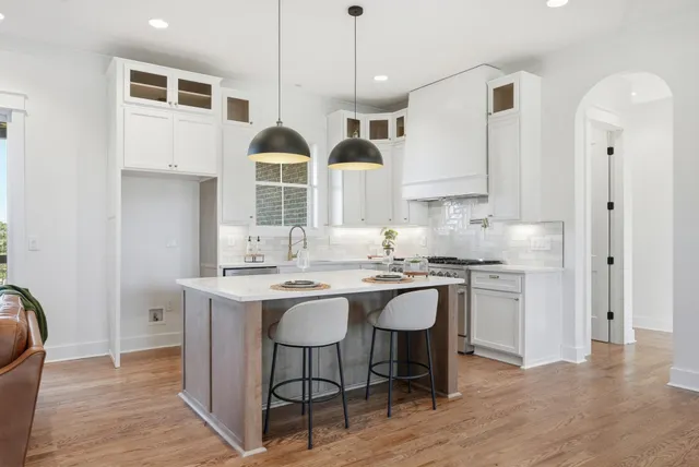 a view of a room with wooden floor and white walls
