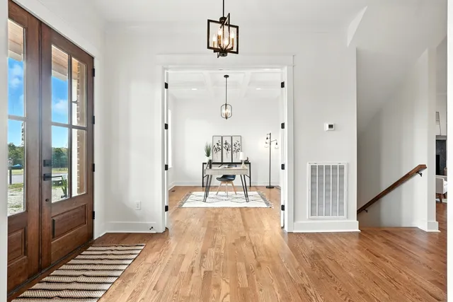 a view of a room with furniture wooden floor and windows