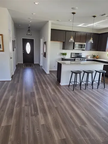 a view of kitchen with cabinets and wooden floor