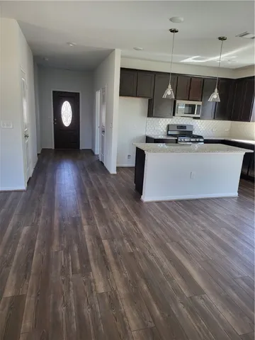 a view of kitchen with cabinets and stainless steel appliances