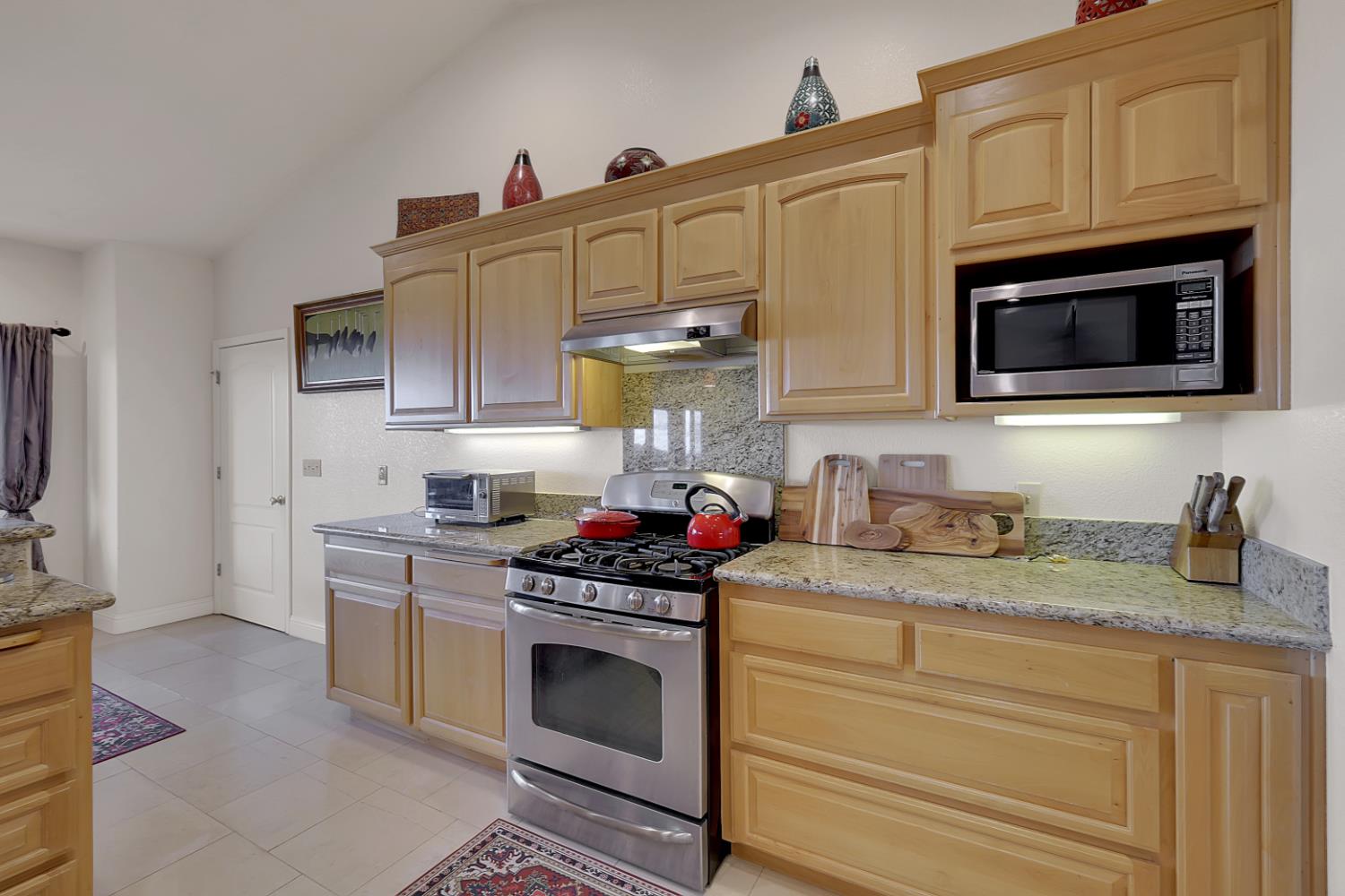 13680 Jessica Way Browns Valley, CA 95918 - Photo 21 of 73 a kitchen with granite countertop a stove sink and microwave