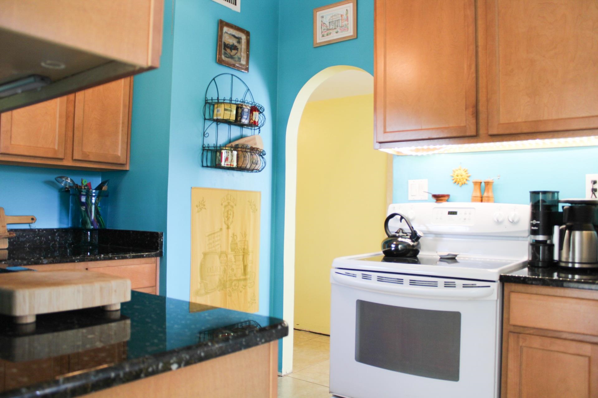 248 Spring Street St. Augustine, FL 32084 - Photo 11 of 50 a kitchen with stainless steel appliances granite countertop a stove a sink and a microwave