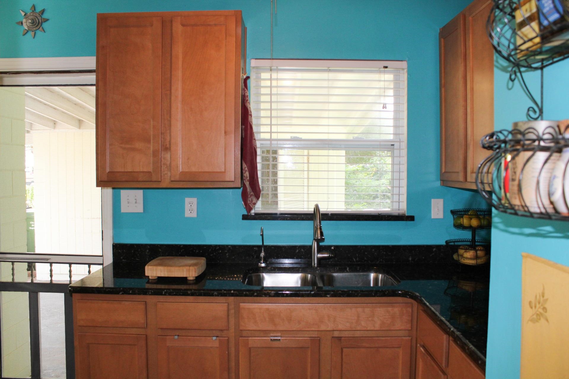 248 Spring Street St. Augustine, FL 32084 - Photo 13 of 50 a kitchen with granite countertop a sink a stove and a microwave