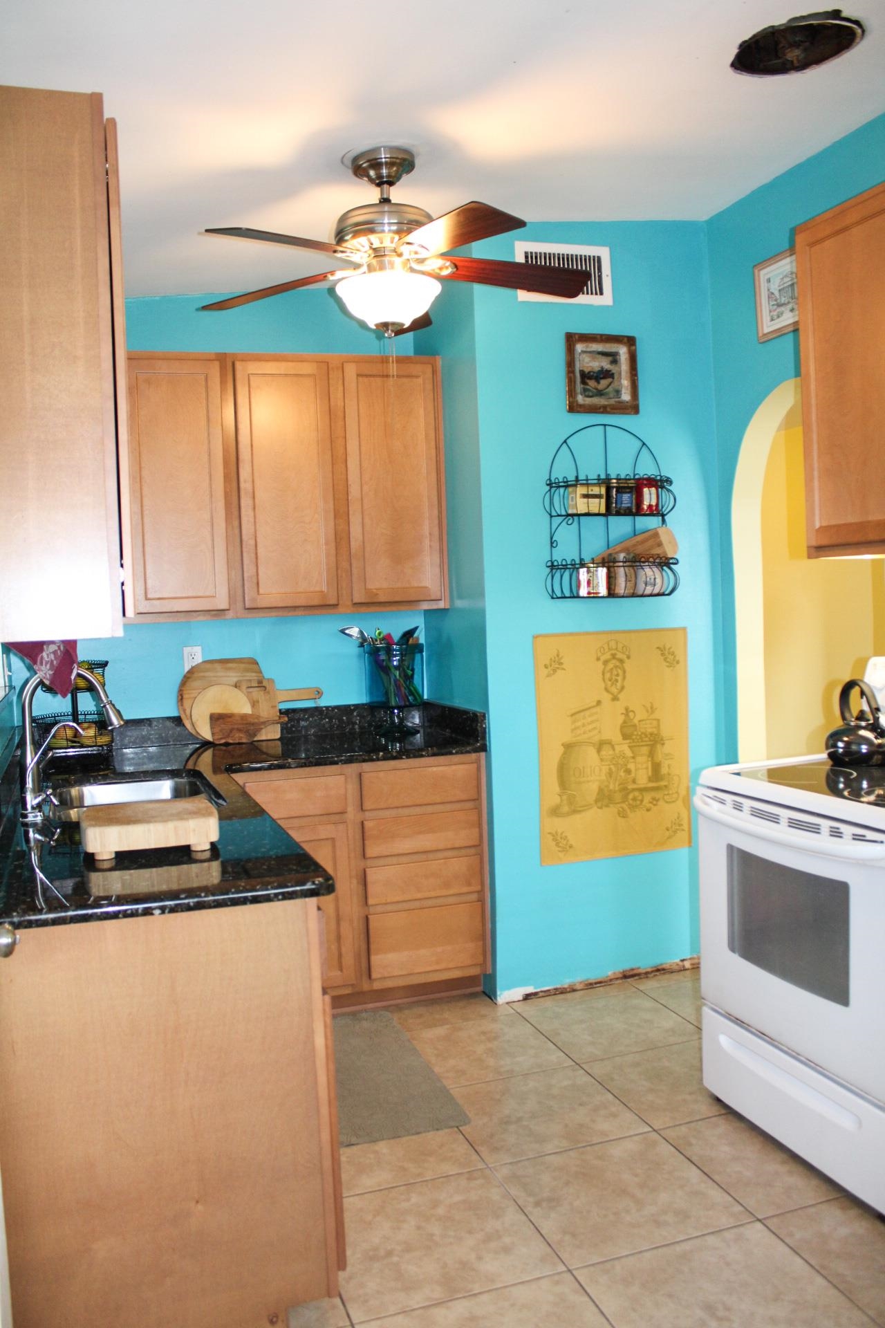 248 Spring Street St. Augustine, FL 32084 - Photo 9 of 50 a kitchen with stainless steel appliances granite countertop a sink stove and cabinets