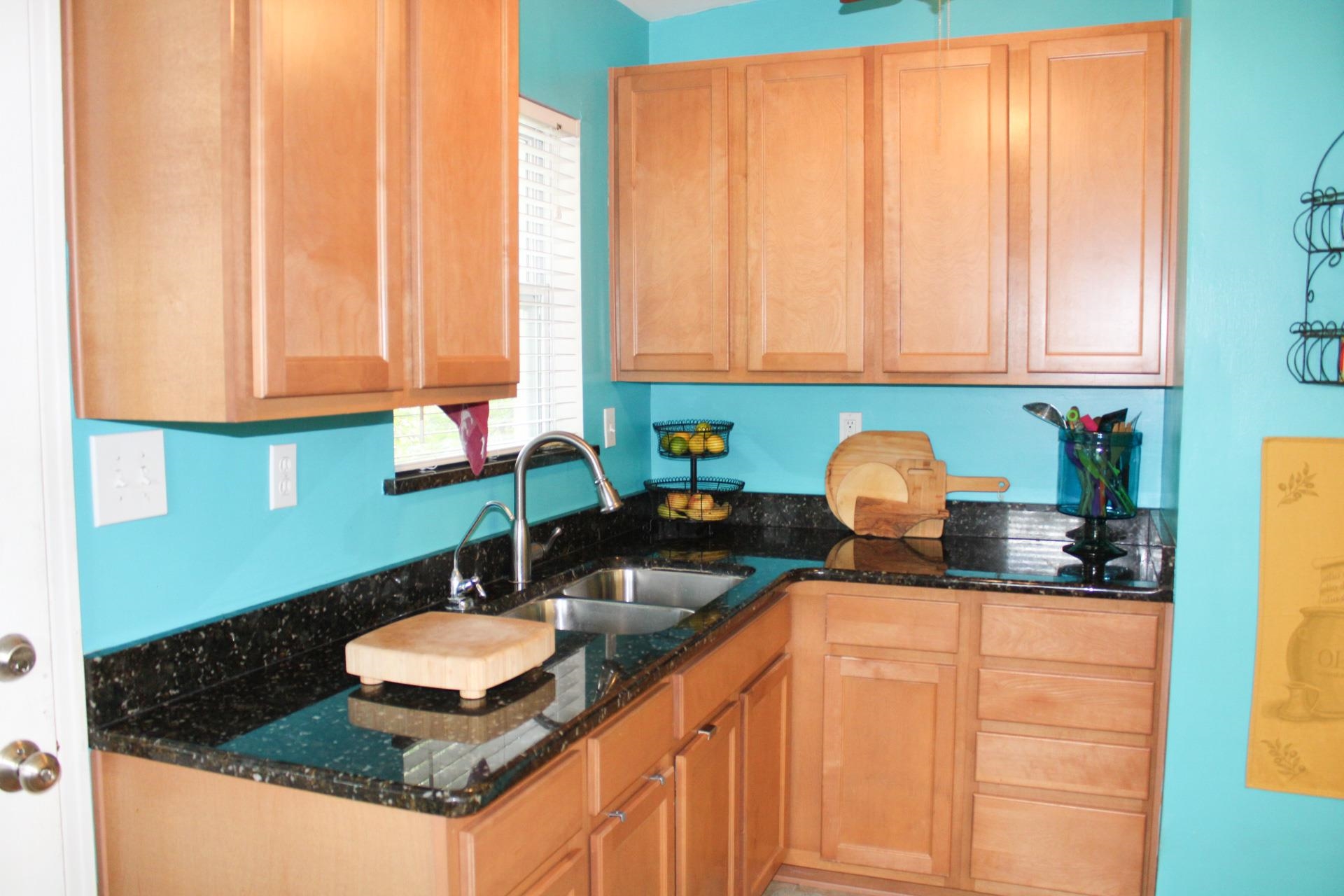 248 Spring Street St. Augustine, FL 32084 - Photo 10 of 50 a kitchen with granite countertop a sink a stove and cabinets