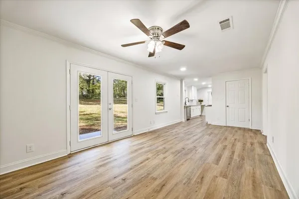 wooden floor in an empty room with a window