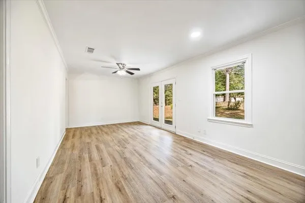 wooden floor in an empty room with a window