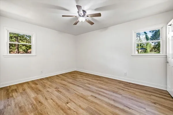 wooden floor in an empty room with a window