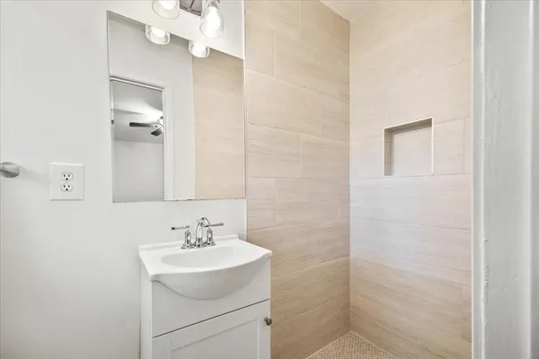 a bathroom with a sink a mirror and a shower