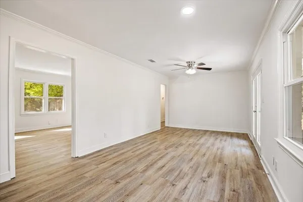 wooden floor in an empty room with a window