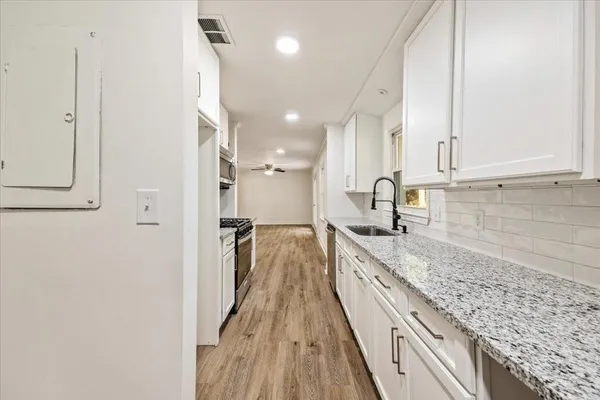 a kitchen with a sink and refrigerator