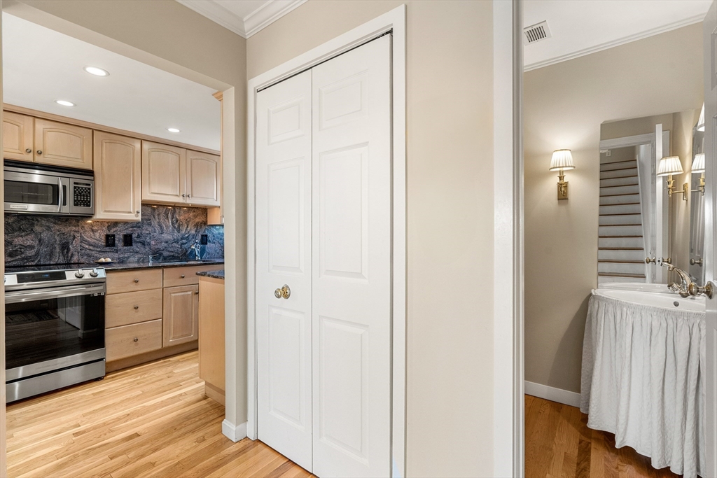 55 Brackett Place, Unit D Marblehead, MA 01945 - Photo 12 of 34 a kitchen with stainless steel appliances granite countertop a refrigerator and a stove top oven