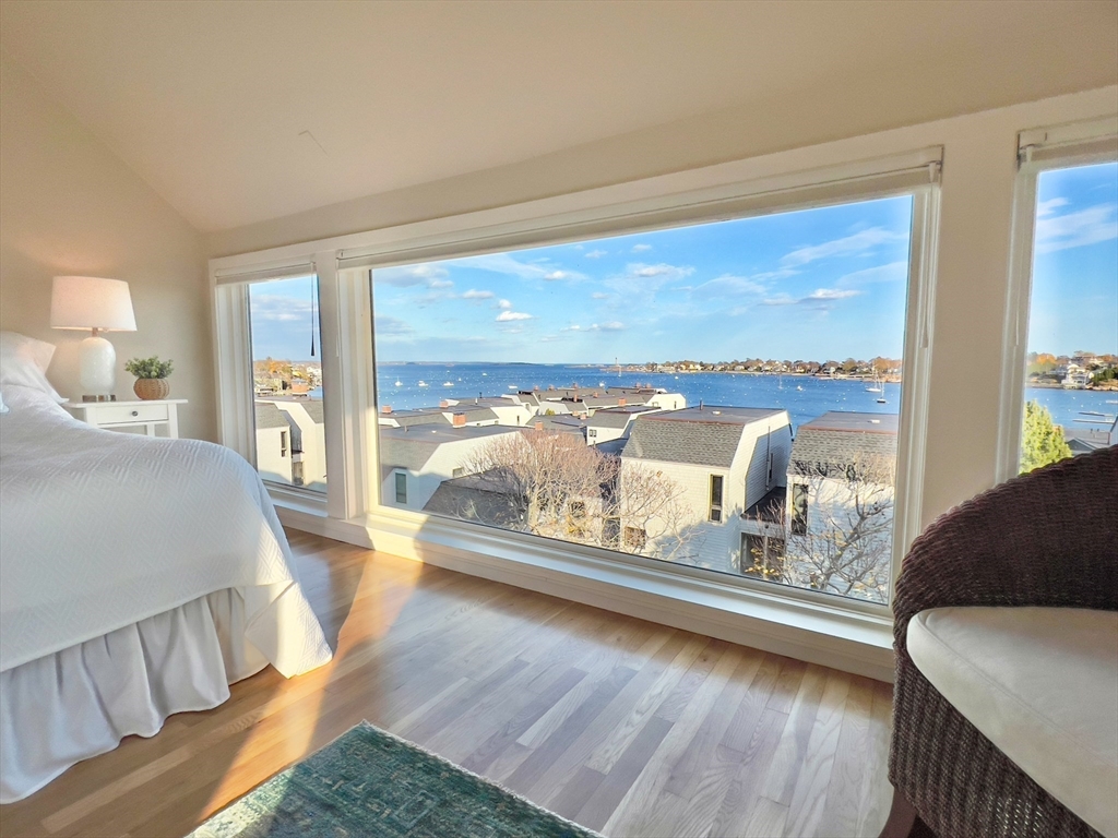 55 Brackett Place, Unit D Marblehead, MA 01945 - Photo 17 of 34 a living room with couch and a large window