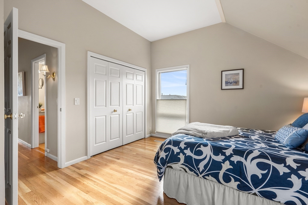 55 Brackett Place, Unit D Marblehead, MA 01945 - Photo 20 of 34 a bedroom with a bed and a painting on the wall