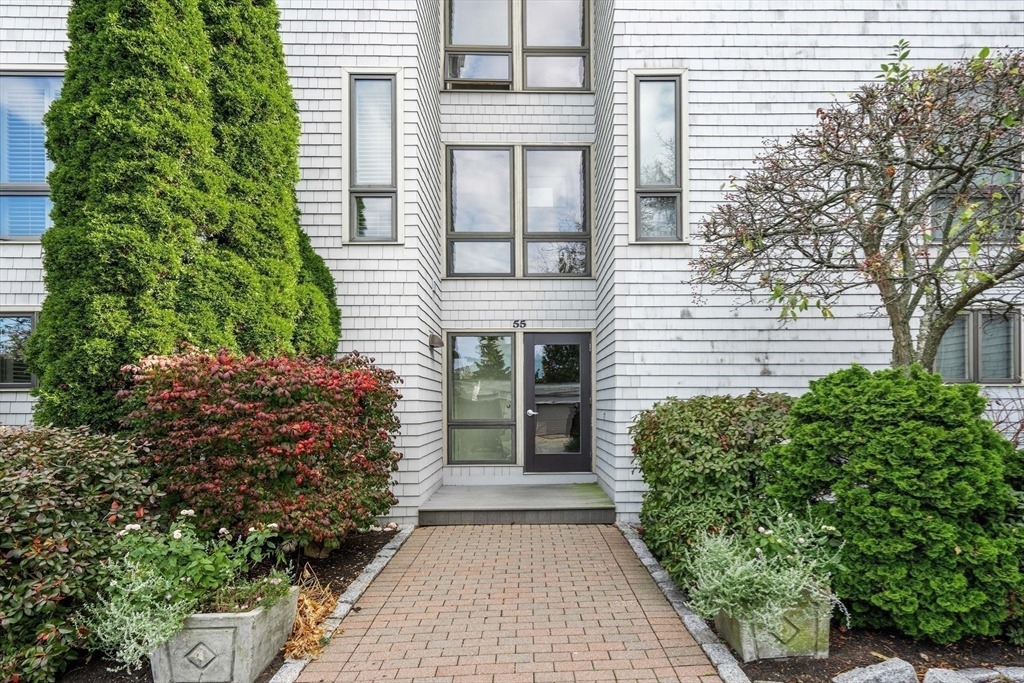 55 Brackett Place, Unit D Marblehead, MA 01945 - Photo 23 of 34 a front view of a house with a garden