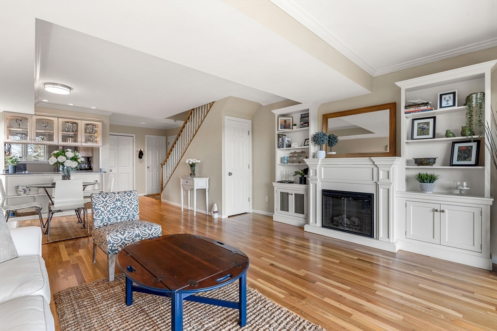 55 Brackett Place, Unit D Marblehead, MA 01945 - Photo 4 of 34 a living room with furniture fireplace and wooden floor